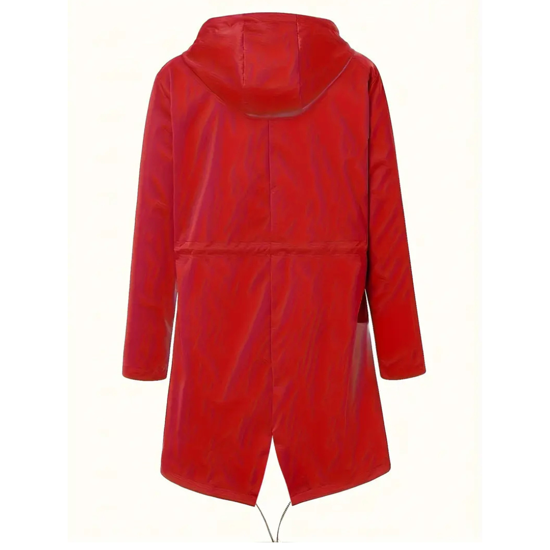 Model wearing a hooded long rain coat with a front zip, drawstring waist, and front pockets on a wet city street._19