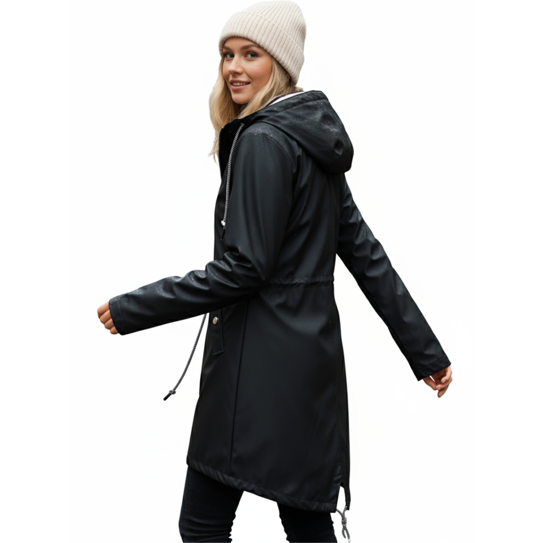 Model wearing a hooded long rain coat with a front zip, drawstring waist, and front pockets on a wet city street._20
