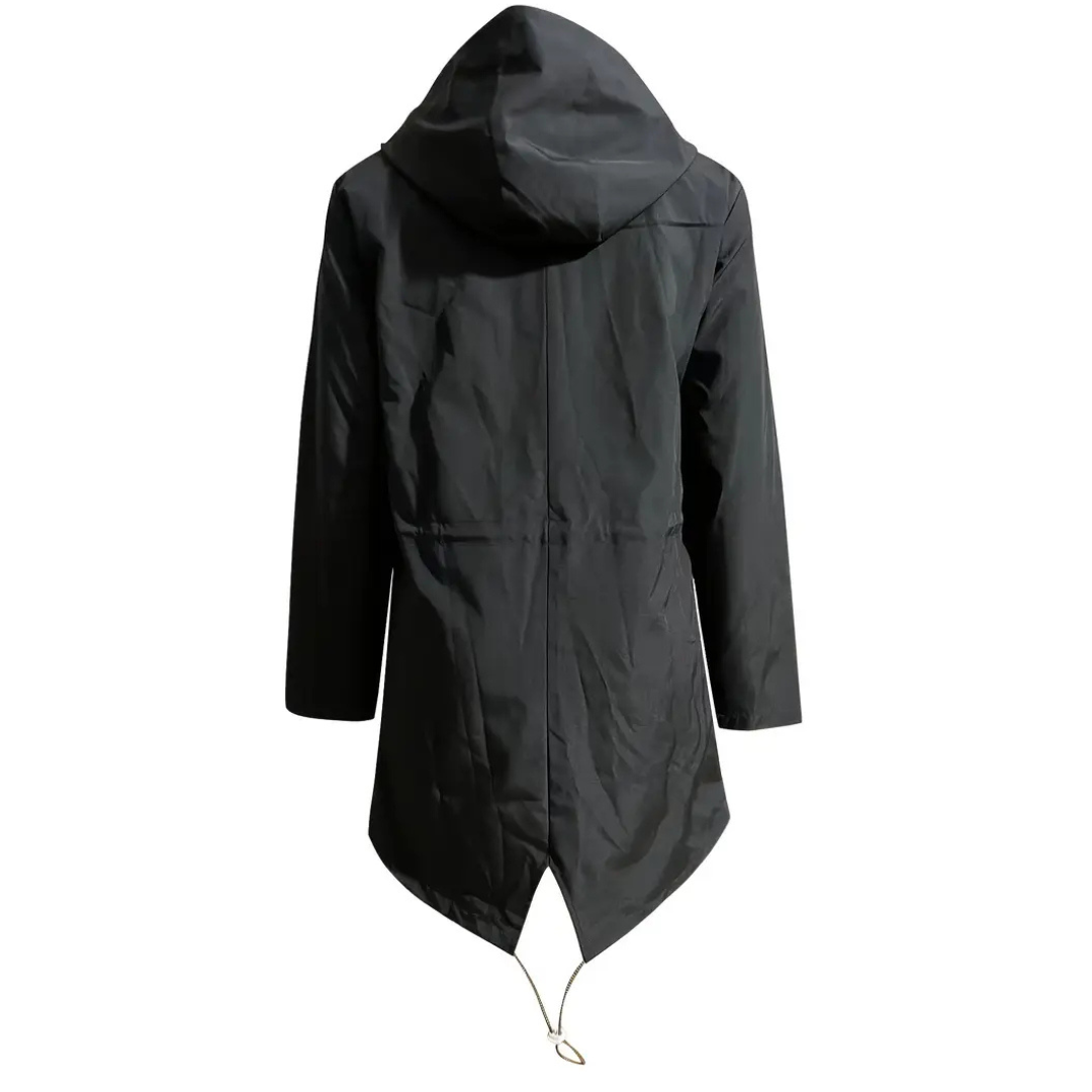 Model wearing a hooded long rain coat with a front zip, drawstring waist, and front pockets on a wet city street._21