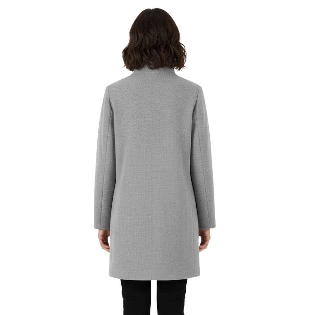 Model wearing a tailored knee length coat with a stand collar, front buttons, and patch pockets._1