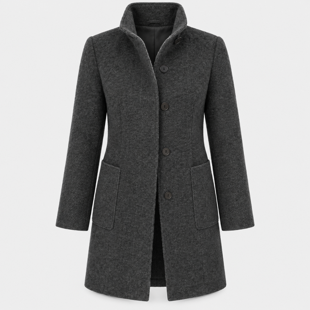 Model wearing a tailored knee length coat with a stand collar, front buttons, and patch pockets._5