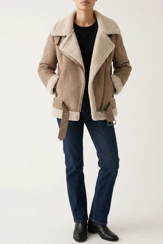 Woman wearing a hip length aviator jacket with a wide fleece collar, asymmetric zip, buckled waist tabs and side pockets, with straight jeans and ankle boots._0